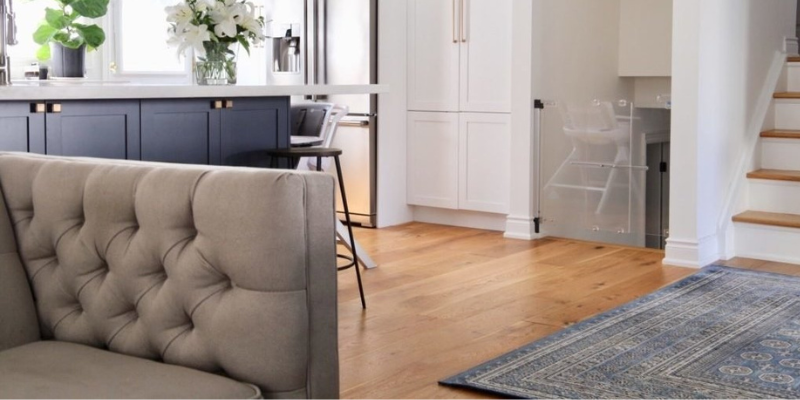 Living room with clear baby gate in hallway