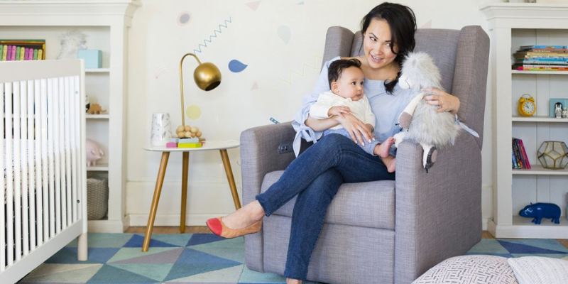 Woman Sitting iN Glider With Baby on Lap 