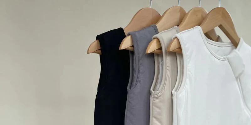 Pip + Phee Sleep Sacks hanging on wooden hangers