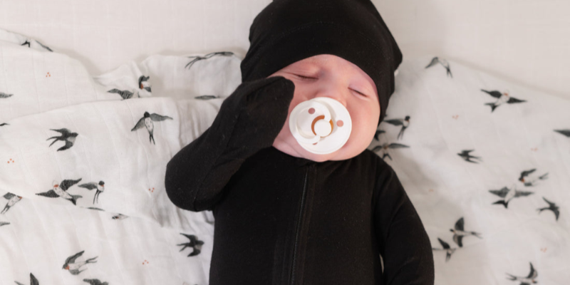 Newborn Baby Lying Down While Wearing Bamboo Fitted Sleeper from Pip + Phee