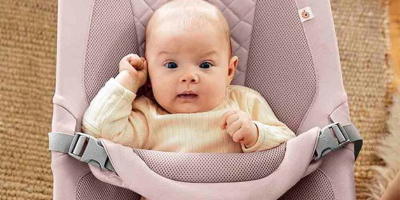 Baby sitting in an Ergobaby 3-in1 Evolve bouncer