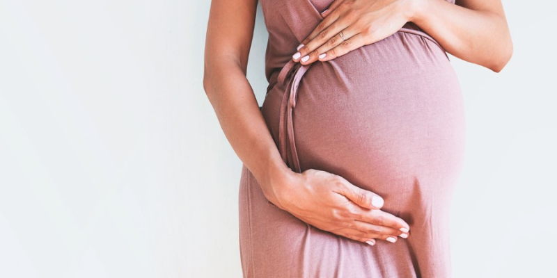 Woman Holding Stomach In Third Trimester