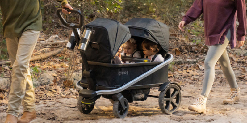 BOB Renegade Wagon Being Pulled With Two Toddlers Sitting Inside