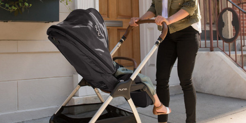 mom pushing toddler in Nuna TRIV Stroller