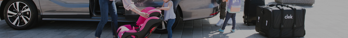 Parents unlocking van with Clek Foonf and Clek Wheelie Travel Car Seat Bag