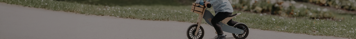 Little boy outside riding on a Kinderfeet Balance Bike in blue