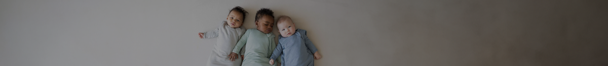 Babies laying down wearing Kyte Bay sleep sacks