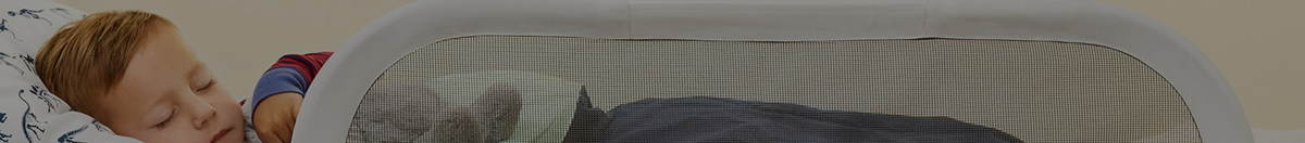 Child sleeping in bed with a bed rail