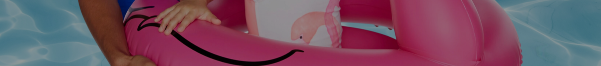 Little girl in a flamingo BigMouth Inc lil' floatie in the water