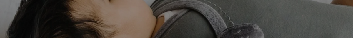 Baby wearing a grey L'ovedbaby bodysuit