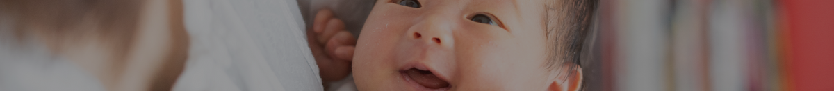 Mom holding smiling baby after using Borion to aid teething pains