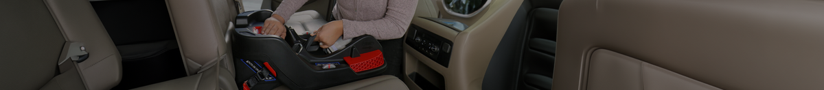 Mom installing a Britax infant car seat base in her vechile