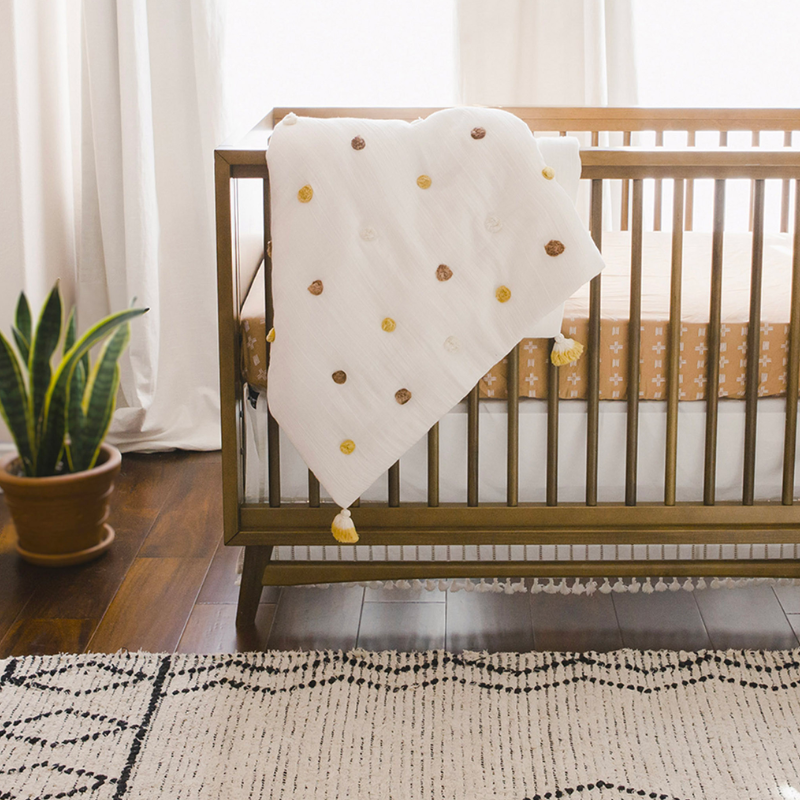 Couverture pour bébé matelassée à pompons